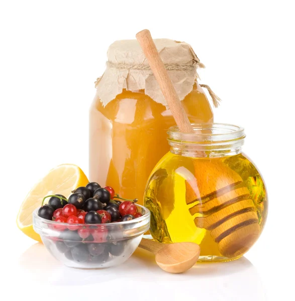 Glass jar full of honey and berry — Stock Photo, Image