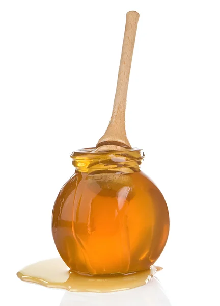 Glass jar full of honey and stick — Stock Photo, Image