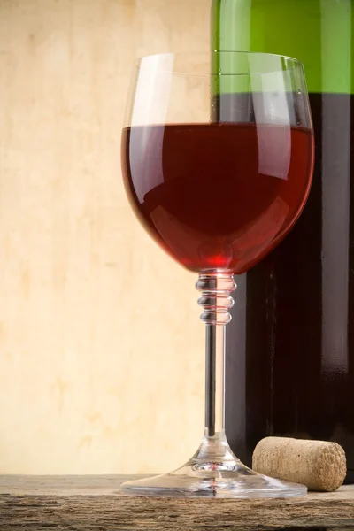 Glass of red wine and bottle — Stock Photo, Image