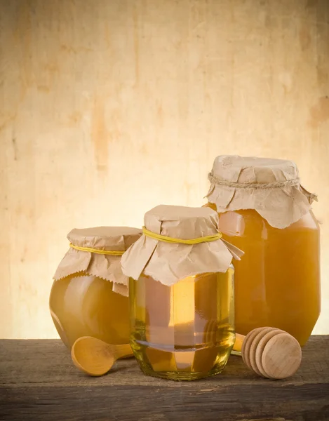 Frasco de mel e pau — Fotografia de Stock