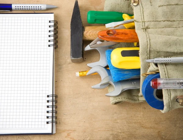 Tools and notebook on wood — Stock Photo, Image