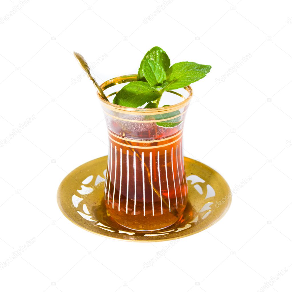 Arabian tea in oriental tea set with mint leaves