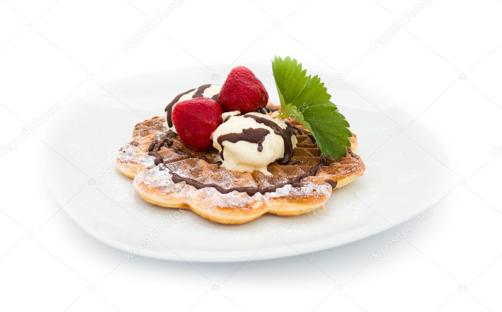 Waffle with vanilla ice cream, strawberries and chocolate sauce