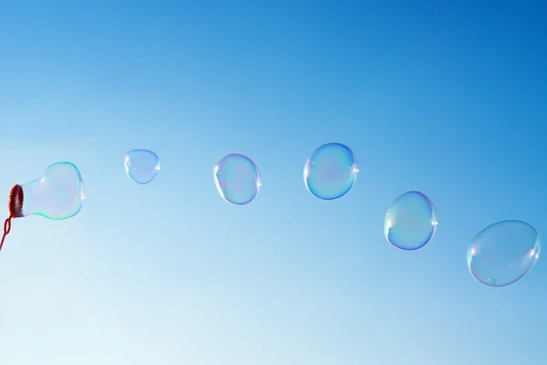 Burbujas de jabón sobre cielo azul claro — Foto de Stock