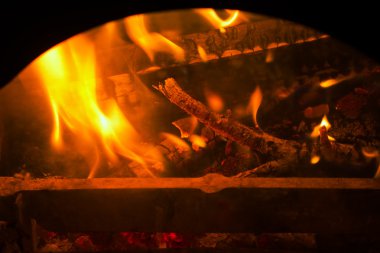 Burning billets in old fireplace clipart