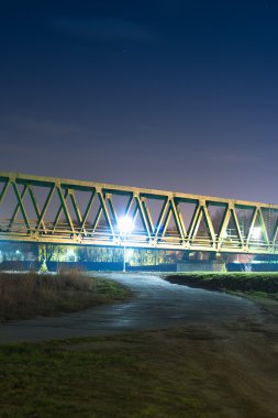 Path to the old railway bridge at night. clipart