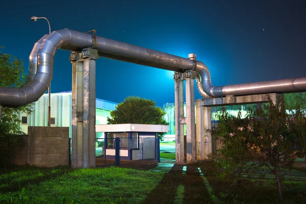 Industrial pipes at night — Stock Photo, Image