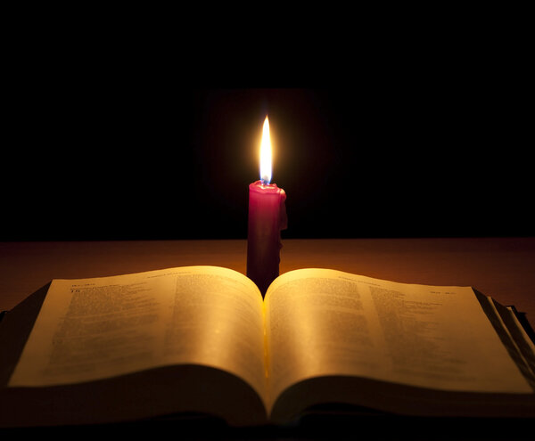 Bible and candle background concept