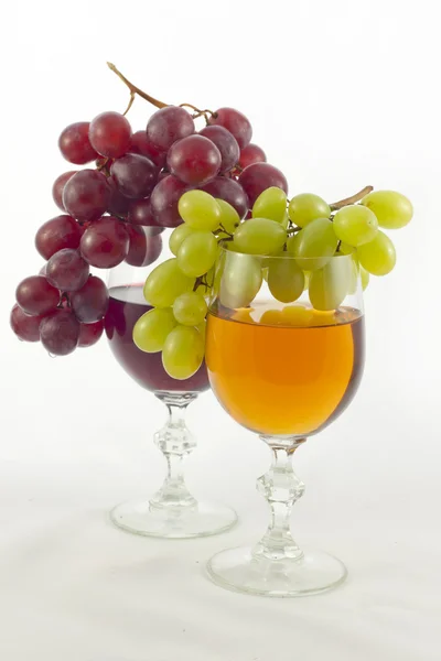 stock image Glass of wine and grapes red and white