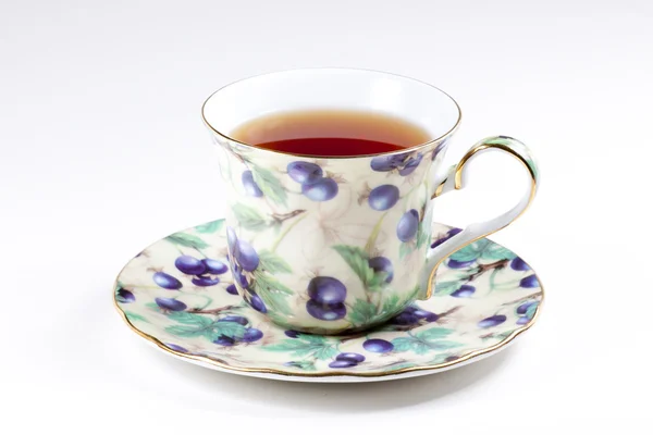 stock image A cup of black tea on a saucer