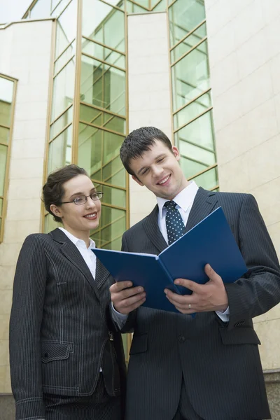 Business looking at results of their work and smiling — Stock Photo, Image