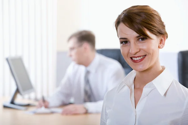 Portrait de femme d'affaires heureuse souriant à la caméra sur fond de travail — Photo