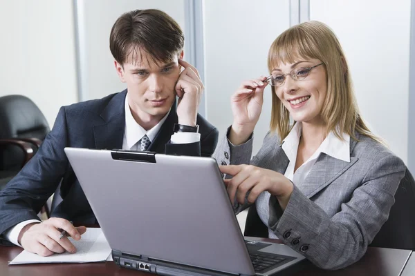 Imagem de dois trabalhando olhando para a tela do laptop no escritório — Fotografia de Stock