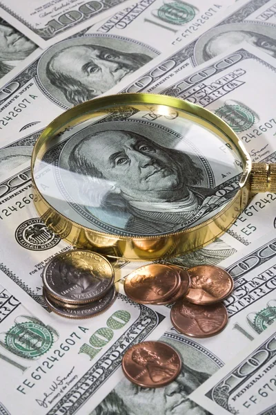 Magnifying glass on money background. — Stock Photo, Image