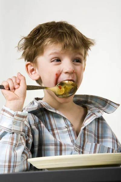 A kisfiú egy kanállal a szájban — Stock Fotó