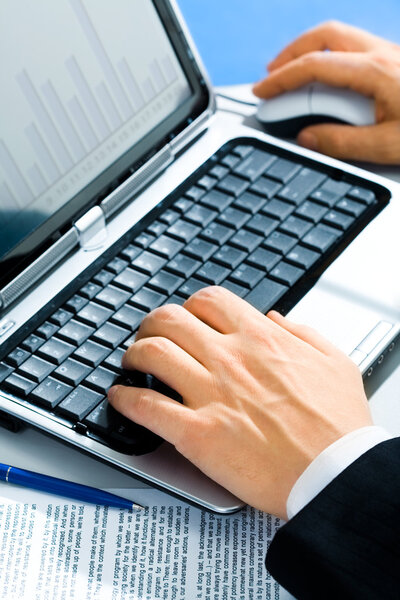 Typical image of hands typing on a laptop