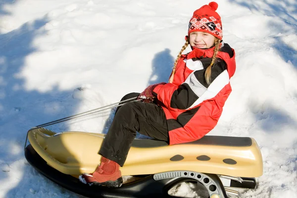 Girl on the sledge — Stock Photo, Image