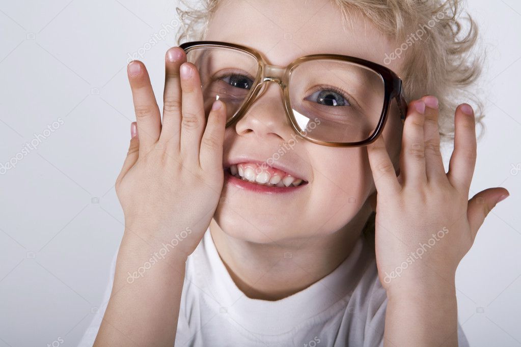 Close Up Of Smart Guy In Preschool Age Looking At Camera Through