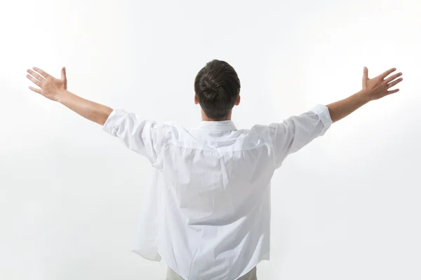 Rear view of man wearing white shirt and stretching his arms — Stock Photo, Image