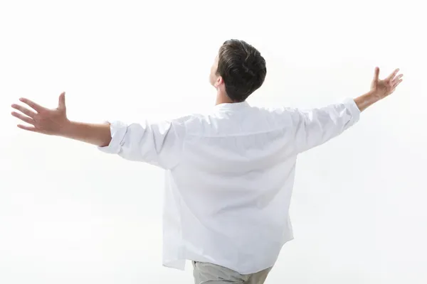 Πίσω όψη του ανθρώπου φορώντας άσπρο πουκάμισο και τεντώνοντας τα χέρια — Φωτογραφία Αρχείου