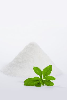 Stevia with a pile of sugar 2 clipart