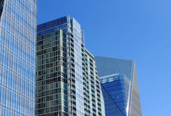 stock image Glass buildings against a blue sky