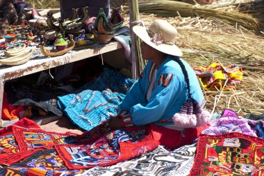 Peruvian woman selling souvenirs on floating island clipart