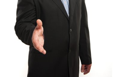 Business man with hand extended to handshake clipart