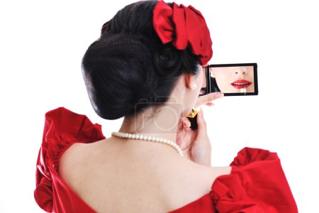 Belle jeune femme appliquant le maquillage 