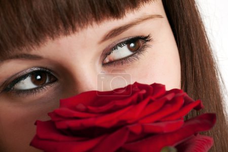 La fille avec une rose sur un fond blanc 