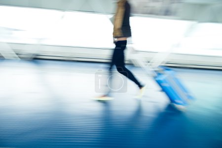 avec leurs valises marchant dans un couloir 