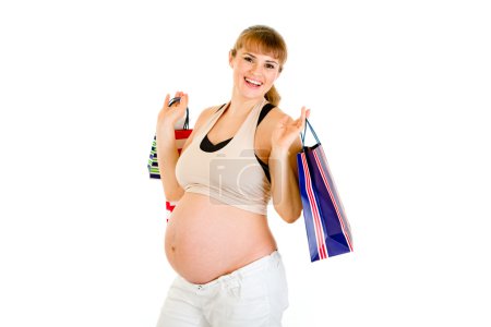 Belle femme enceinte tenant des sacs à provisions dans les mains 